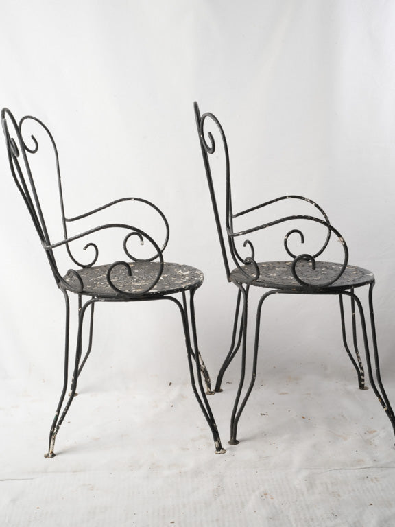 Antique black wrought iron armchairs  