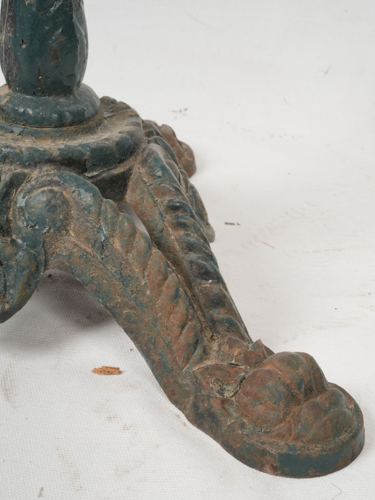 Antique, patina-infused, round cast iron table
