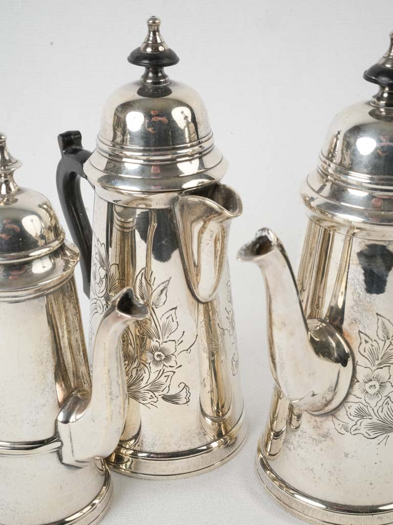 Ornate wood-handled silver coffee pots