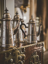 Opulent wood-accented silver coffee pots