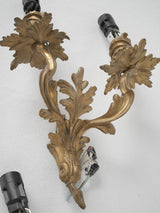 Intricate two-arm gilded sconces