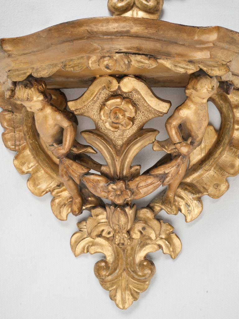 Intricately carved cherub wall fixtures