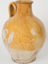 Antique, vibrant yellow Provençal wine pitcher