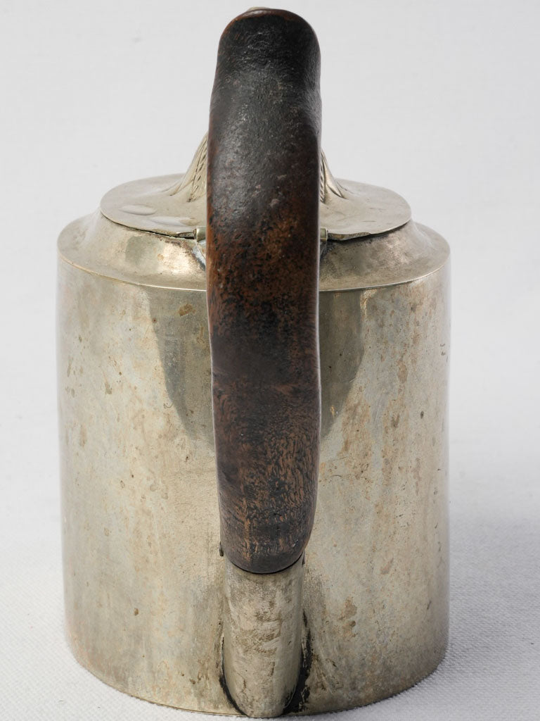Subtly curved silver teapot handle