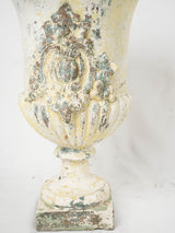 Aged, elegant painted Medici urns