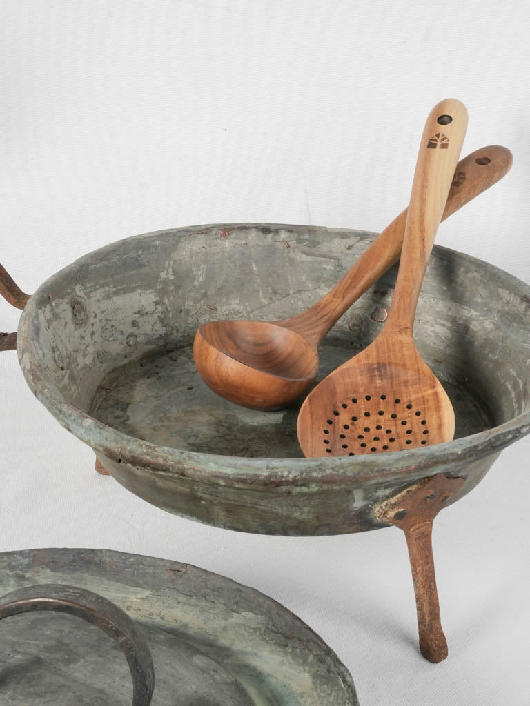 Rusted, iron-legged copper marmite pot