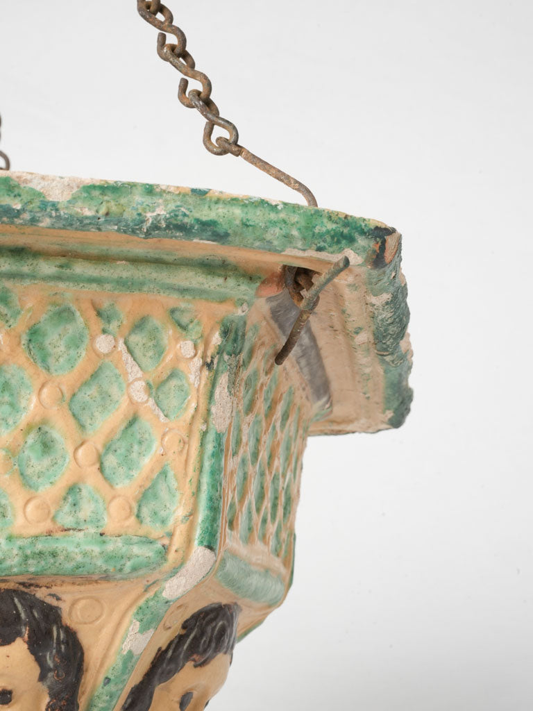 Distinctive face-adorned terracotta planter