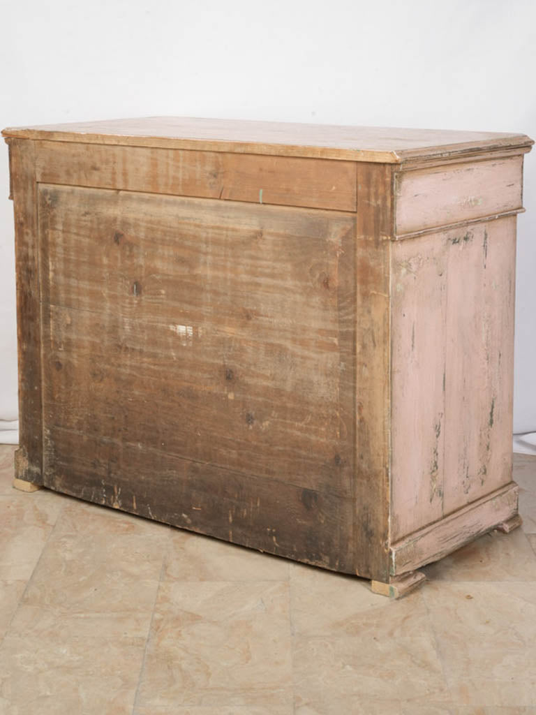 Blush-toned antique-themed dresser.