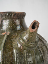 Time-worn dark green ceramic jar