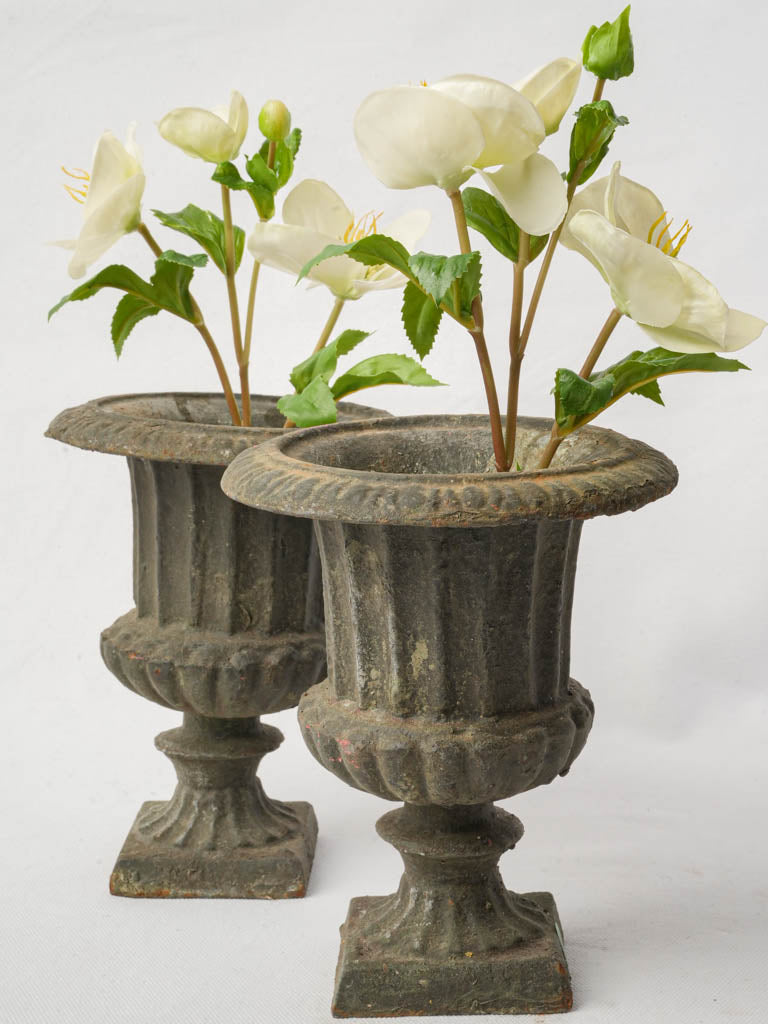 Antique weathered cast iron urns