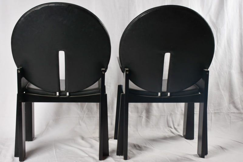 Antique black leather armchairs, worn-in
