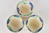 Beige glazed bowls with green trim