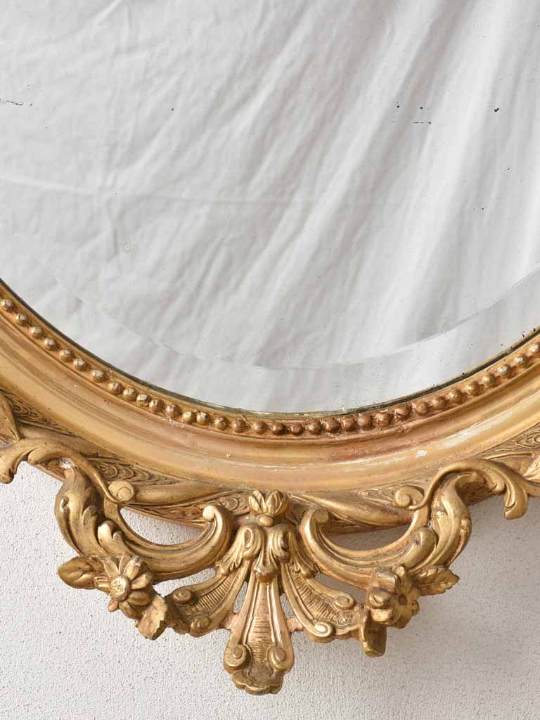 Gilded stucco and timber oval mirror