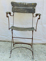 Four antique French iron and timber slatted garden armchairs