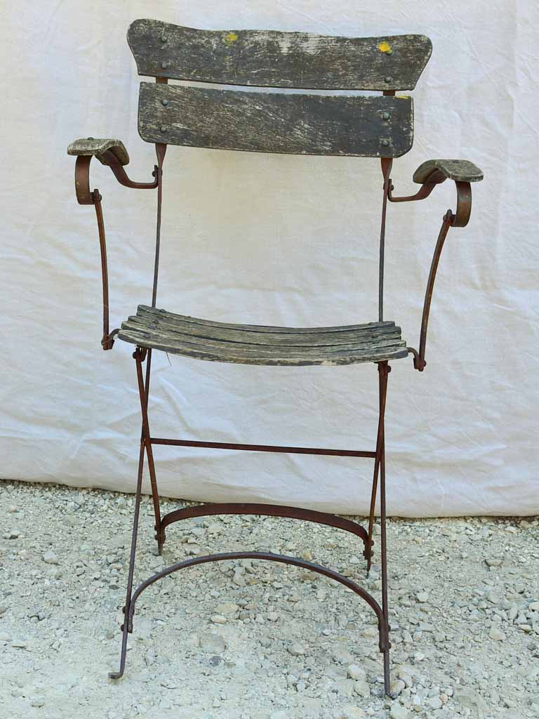 Four antique French iron and timber slatted garden armchairs