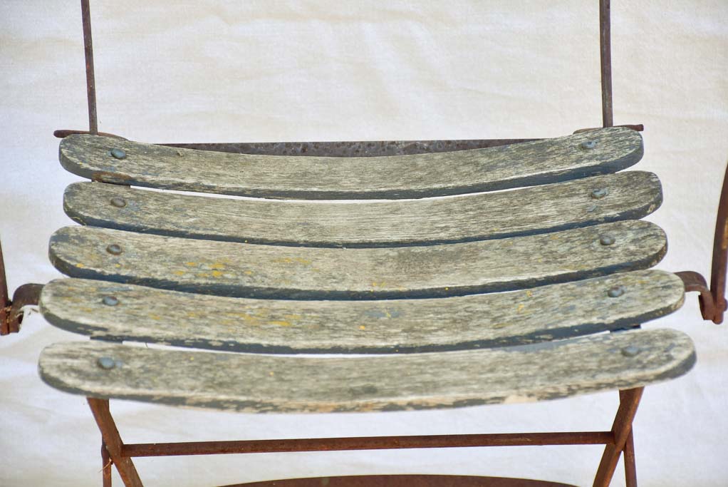 Four antique French iron and timber slatted garden armchairs