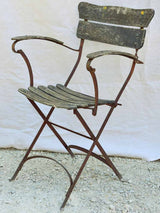 Four antique French iron and timber slatted garden armchairs