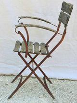 Four antique French iron and timber slatted garden armchairs