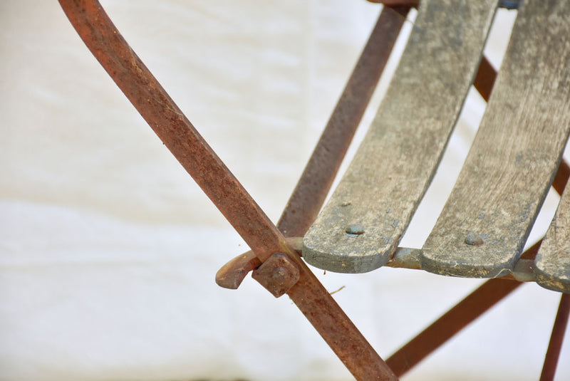 Four antique French iron and timber slatted garden armchairs