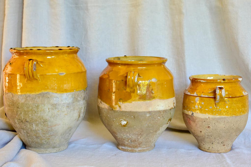 Collection of three antique French confit pots with ochre glaze