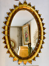 Oval sunburst mirror with sculptural leaf frame