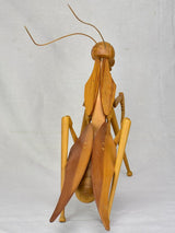 Vintage wooden sculpture of a huge praying mantis