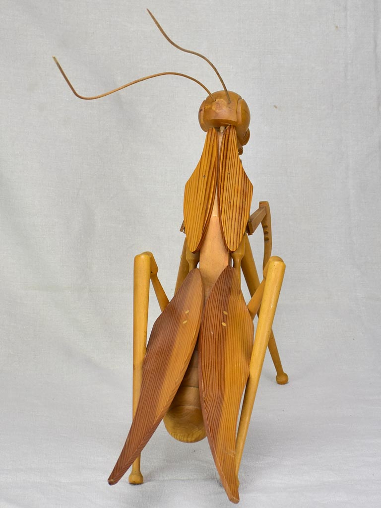 Vintage wooden sculpture of a huge praying mantis