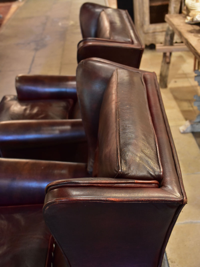 Pair of 1950’s leather wingback armchairs