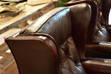 Pair of 1950’s leather wingback armchairs