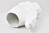 Old-fashioned white snail-shaped decor vase