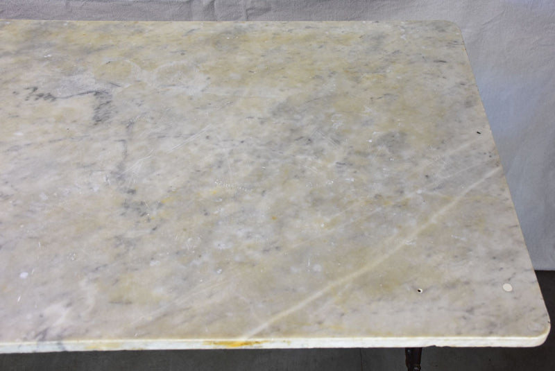 Late nineteenth century French marble presentation table with cast iron base 23¾" x  40½"