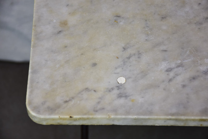 Late nineteenth century French marble presentation table with cast iron base 23¾" x  40½"