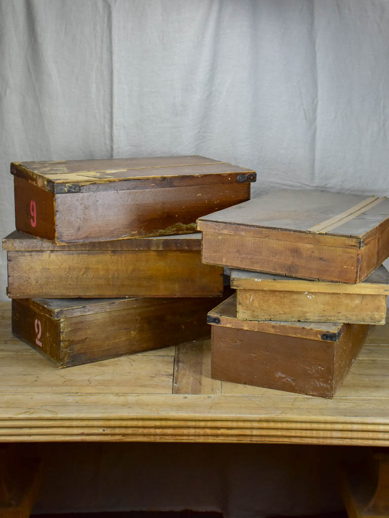 Collection of six large antique wooden boxes from a fabric boutique