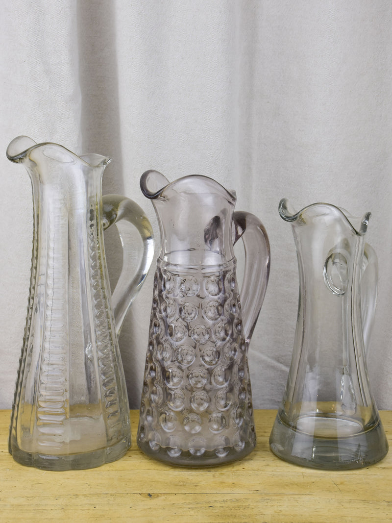 Three antique French pitchers with hand blown glass