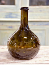 Small antique 'onion' bottle with dark green glass