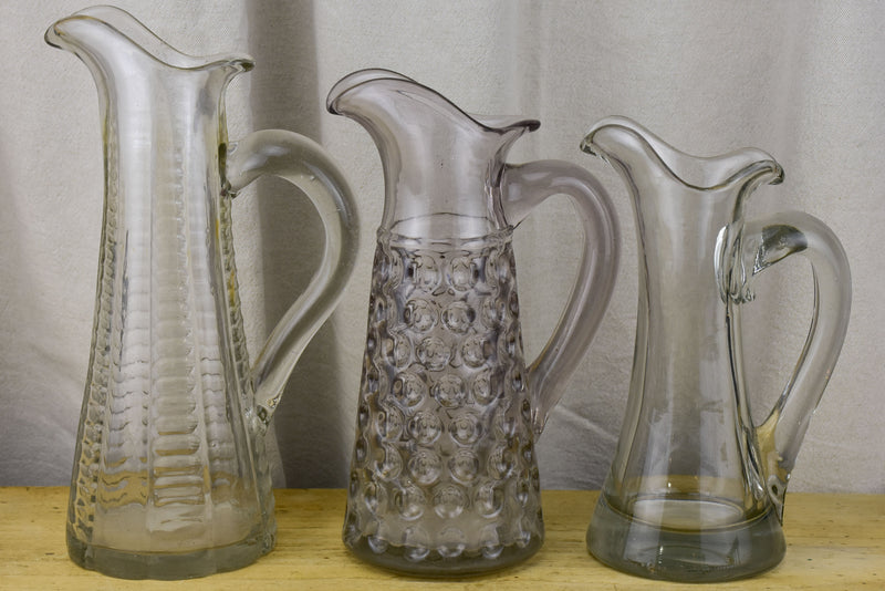 Three antique French pitchers with hand blown glass
