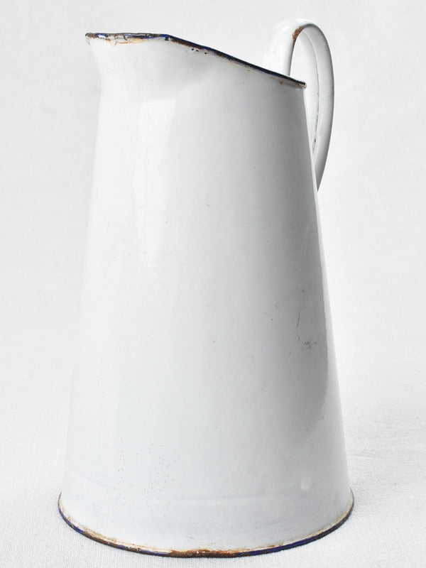 Mid-century enamel pitcher with blue rim