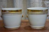 Pair of antique French porcelain pot stands with gold lion's heads
