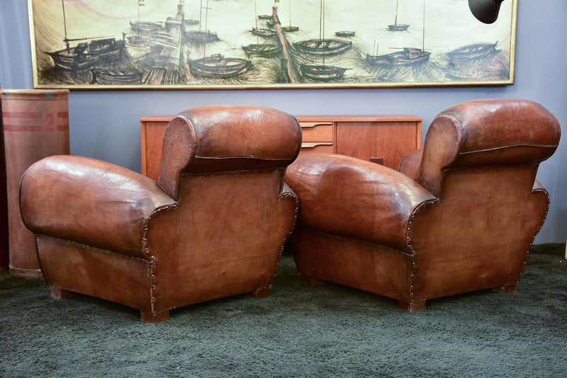 Pair of French leather club chairs with scroll back - pair one