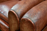Pair of French leather club chairs with scroll back - pair one