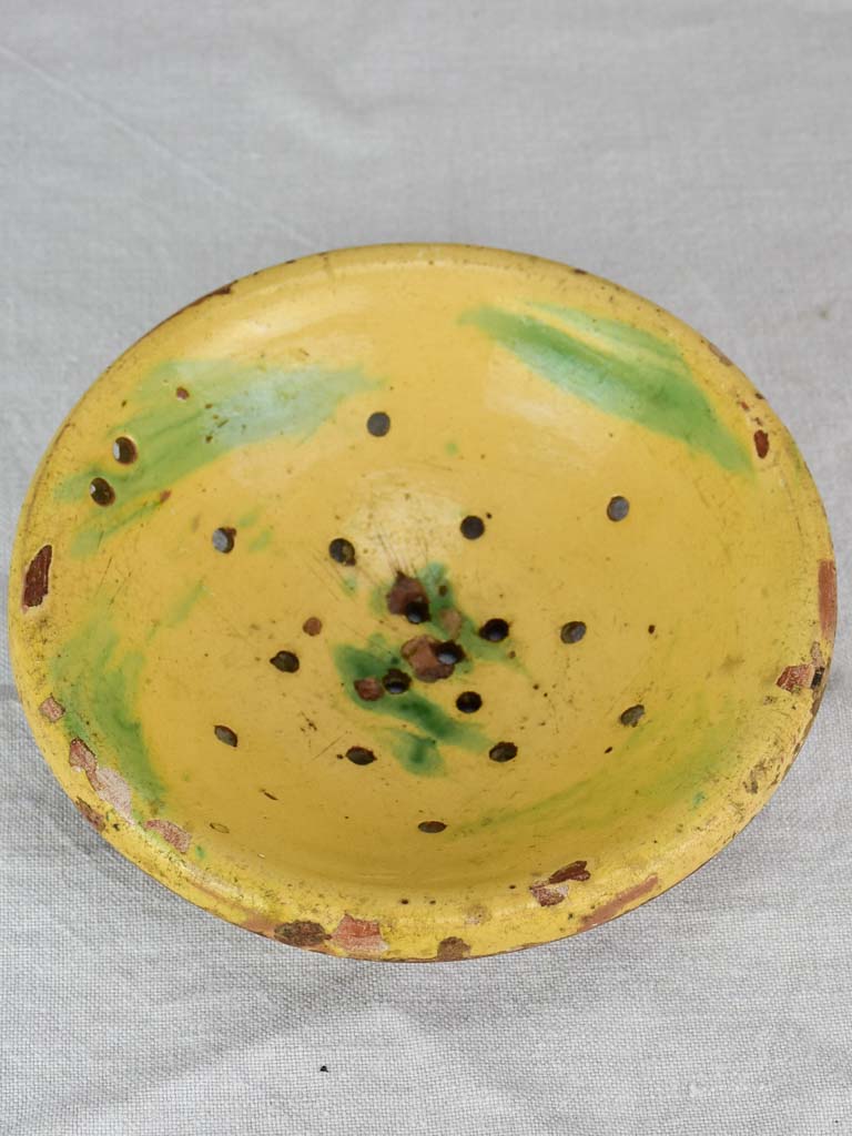 Antique French fruit strainer with yellow and green glaze 9"