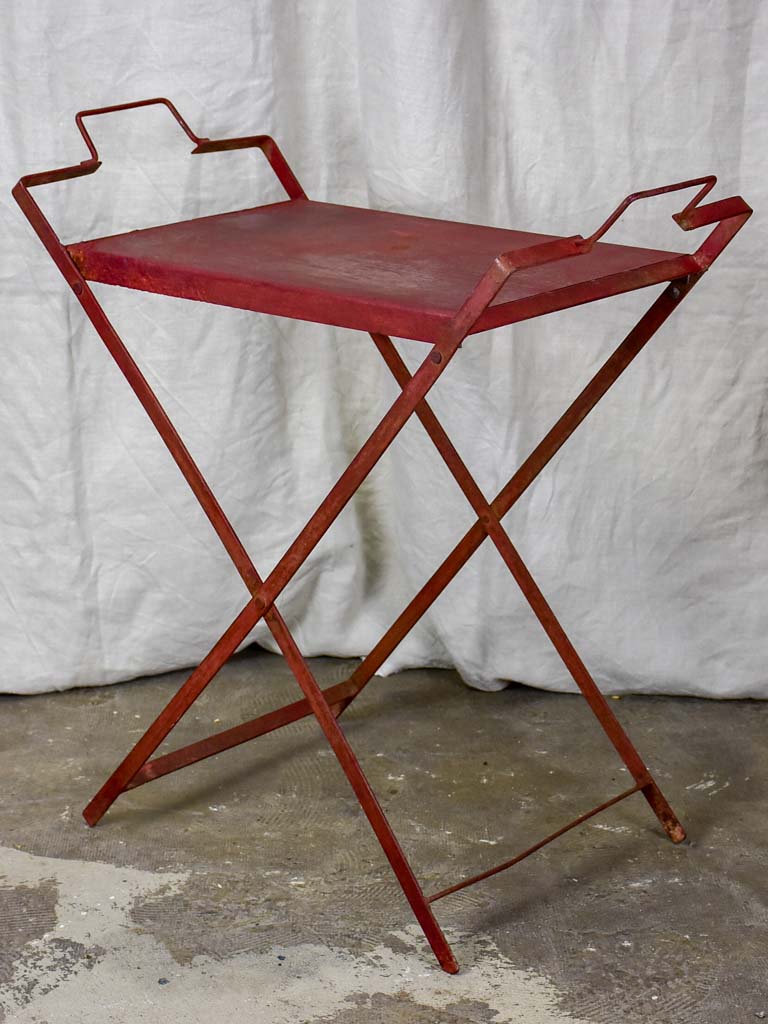 Red industrial French table made from salvaged materials