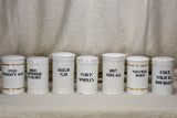 Collection of 7 white antique French apothecary jars with lids