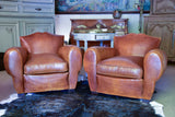 Pair of 1950's moustache back leather club chairs