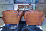 Pair of 1950's moustache back leather club chairs