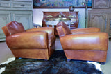Pair of 1950's moustache back leather club chairs