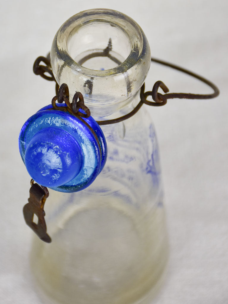 Antique French glass milk bottle with blue decoration