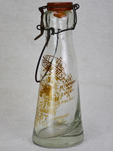 Antique French glass milk bottle with brown decoration