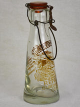 Antique French glass milk bottle with brown decoration