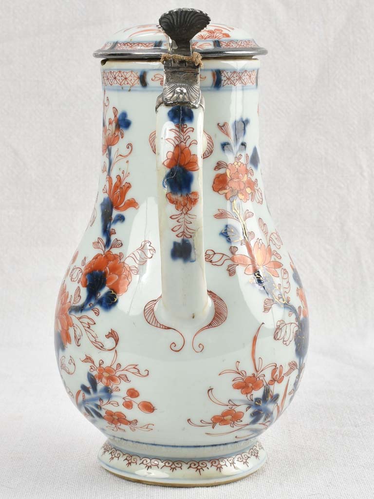 Ancient porcelain pitcher with silver mounts
